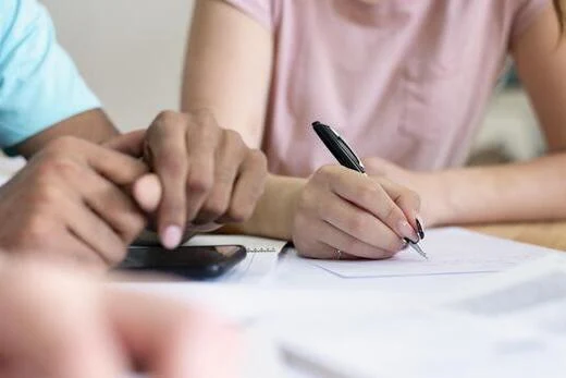 Parents reviewing and signing a child custody agreement during a legal consultation.
