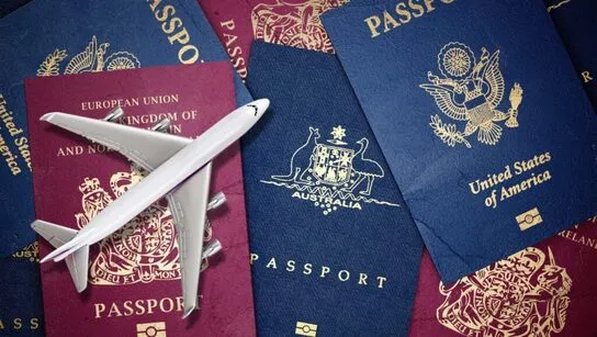 Passports with a toy airplane.