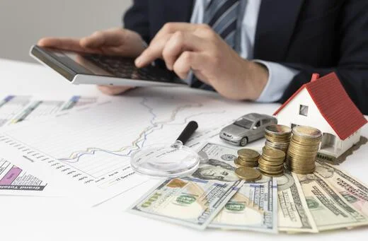 Professional reviewing offshore trusts and asset protection, represented by money, real estate, and investments.