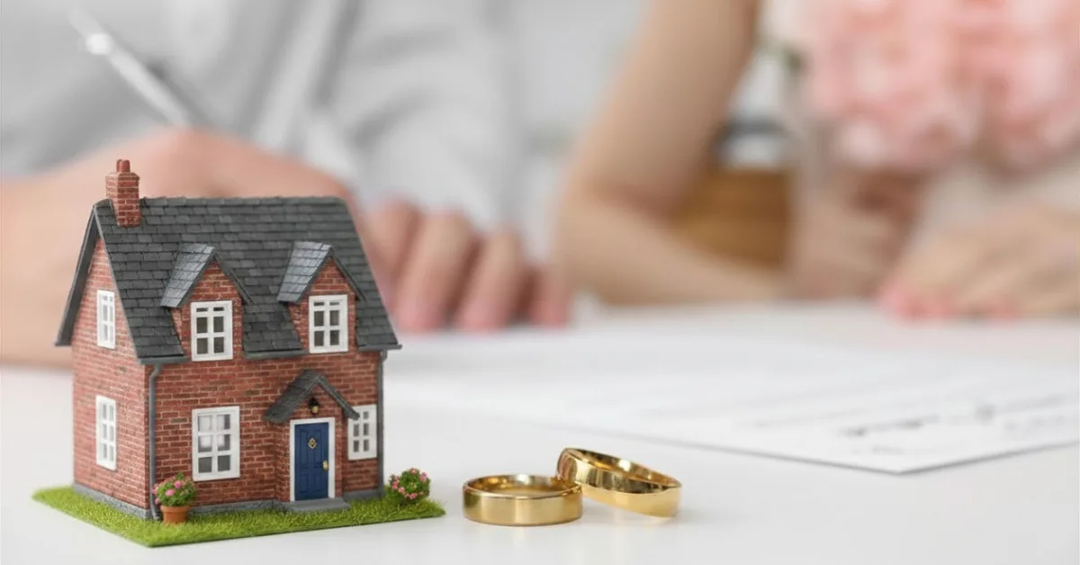 Couple signing their prenuptial agreement that set the marital property regime
